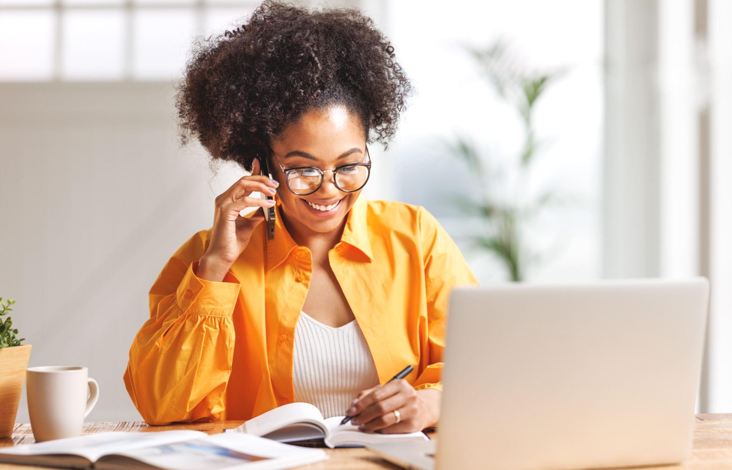 Person reviewing budget spreadsheet with calculator and coffee
